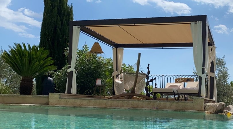 Shade cloth for pergola over a pool